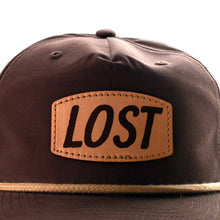 Load image into Gallery viewer, Brown cap with a leather patch displaying the word 'LOST' on a white background